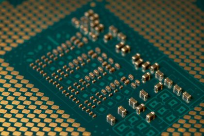 Close-up de um microprocessador montado em uma placa de circuito, com trilhas e componentes eletrônicos visíveis.